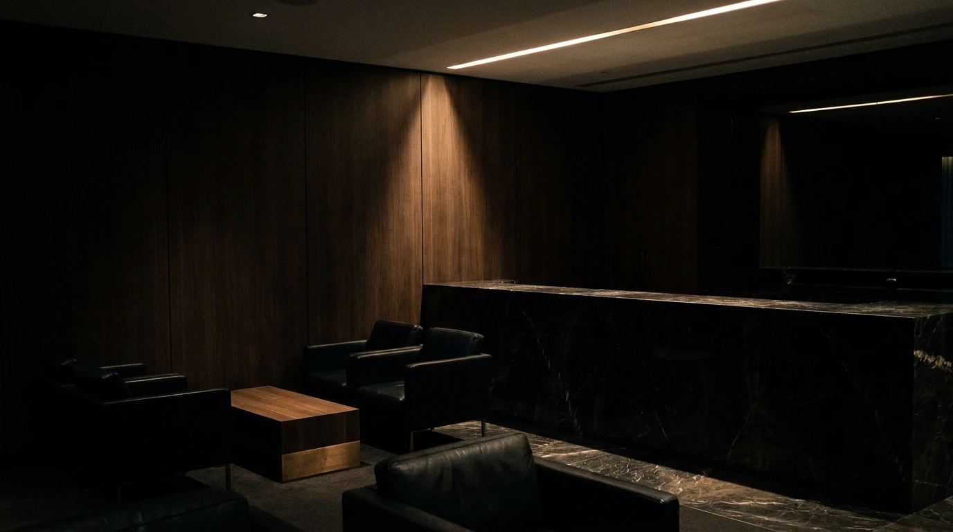Darkened upscale lounge bar at Cruise Club Cairns, a gay club in Cairns, with black leather seating picked out by a single low downlight